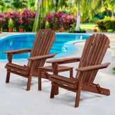 Two brown wooden chairs by a pool with a garden in the background