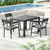 Outdoor dining set with table and chairs by a pool