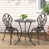 Outdoor patio set with round table and two chairs on a deck.