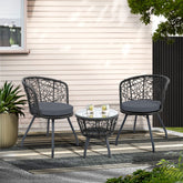 Outdoor patio set with two chairs and a table on a patio area.