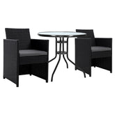 Black wicker outdoor furniture set with a round glass table on a white background