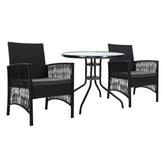 Black wicker dining set with round table and chairs on a white background