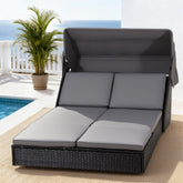 Gray outdoor lounge chair with cushions on a patio with pool and ocean view