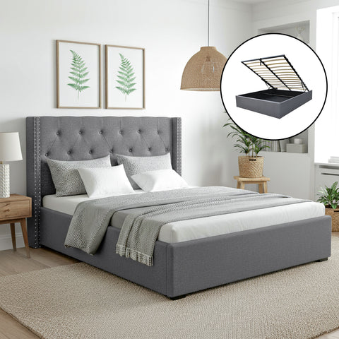 Gray upholstered bed with tufted headboard in a bedroom setting.
