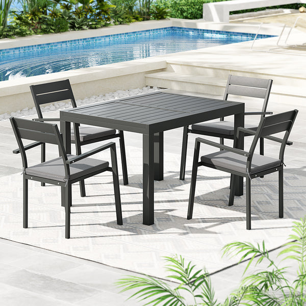Outdoor dining set with table and chairs by a pool