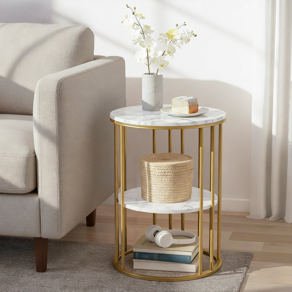 Small round marble-top side table with gold metal frame in a living room setting.