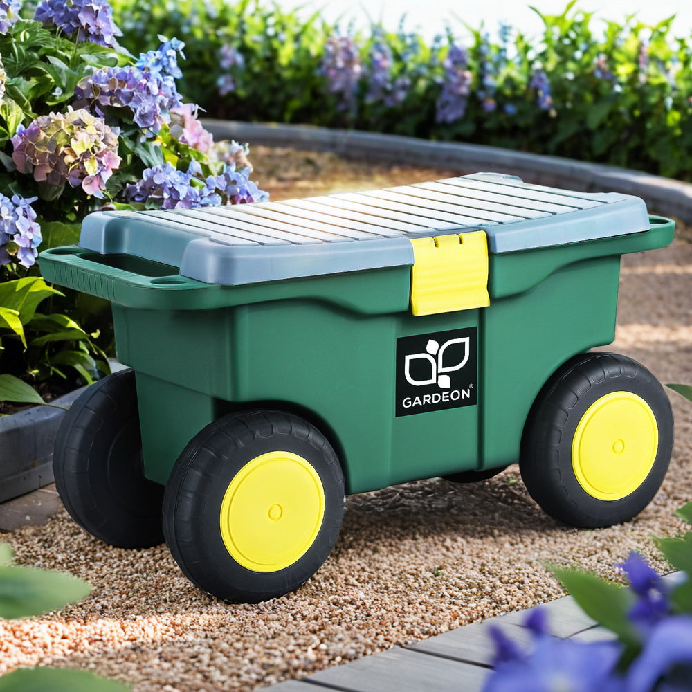 Green garden storage box with yellow wheels on a garden path