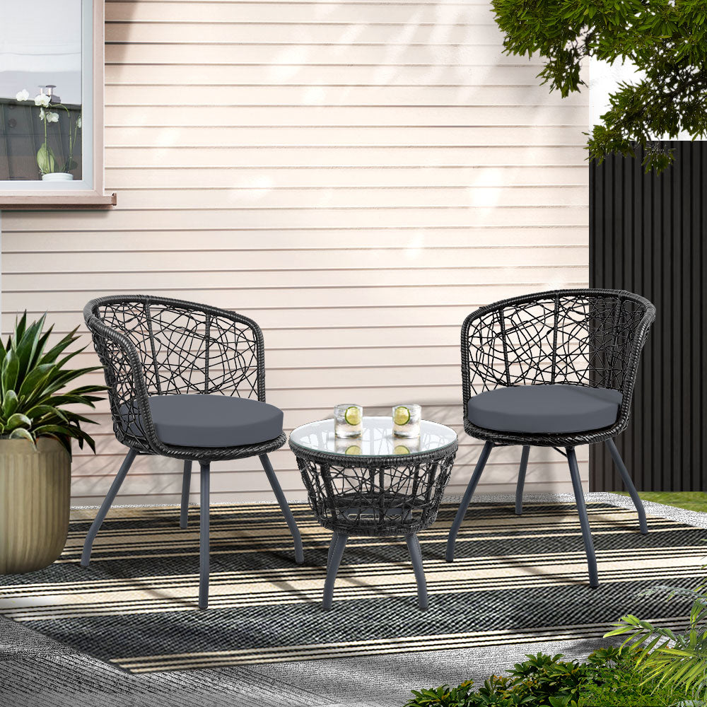 Outdoor patio set with two chairs and a table on a patio area.