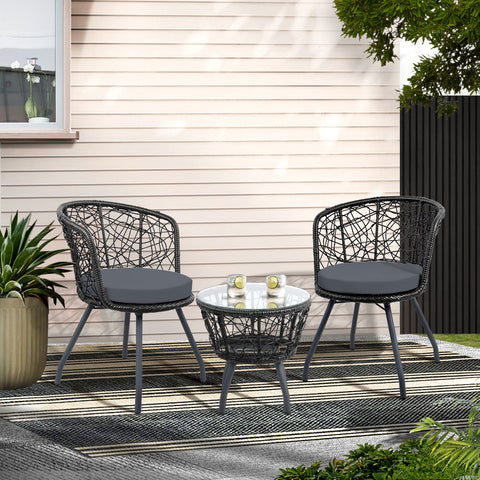Outdoor patio set with two chairs and a table on a patio area.