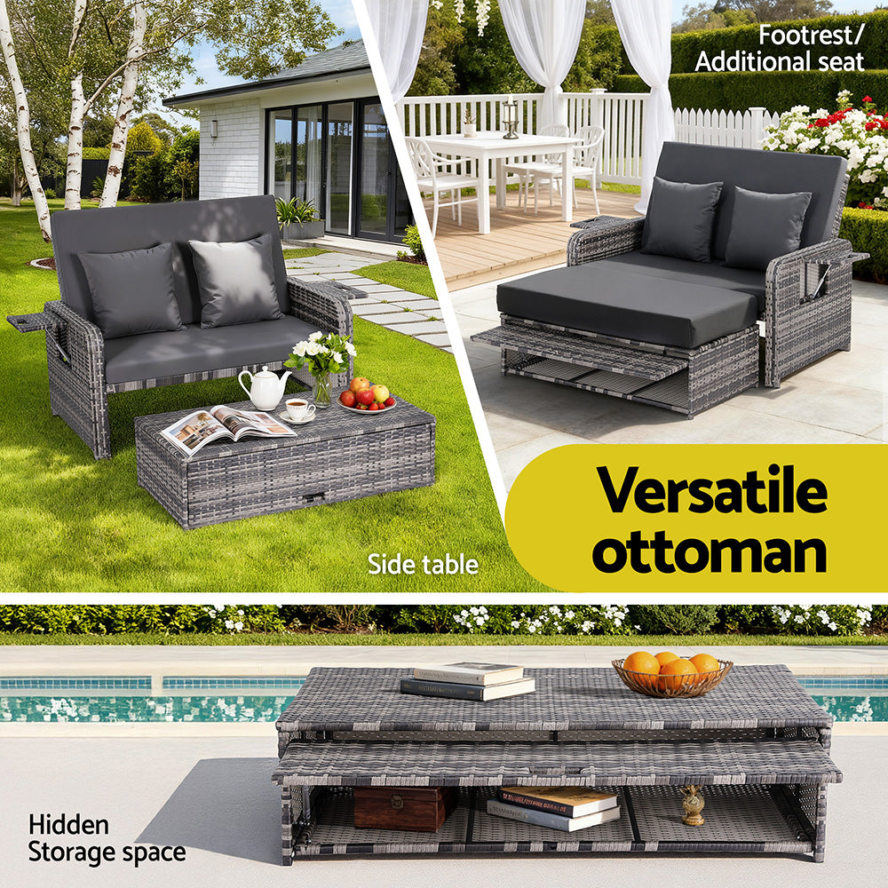 Outdoor furniture set with ottoman, sofa, and side table in a garden setting.