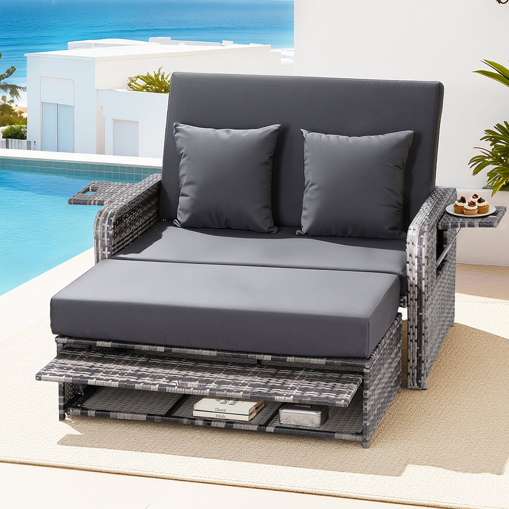 Gray outdoor lounge chair with cushions by a poolside.