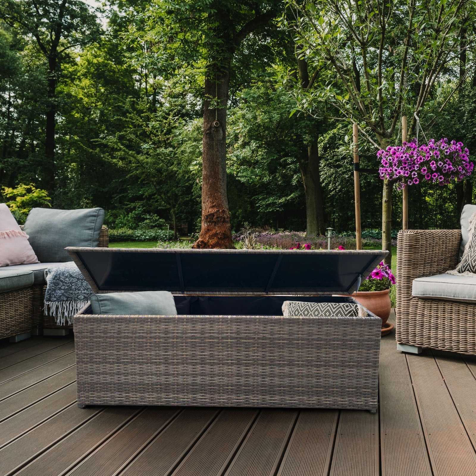 Outdoor patio setting with wicker furniture and a fire pit on a wooden deck.